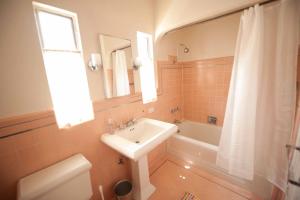 a bathroom with a sink and a tub and a toilet at The Marlowe Family Suite in Santa Barbara +11 photos