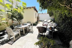 an outdoor patio with a table and chairs at The Marlowe Family Suite in Santa Barbara