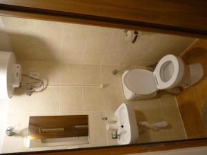 a bathroom with a toilet and a toilet paper dispenser at Pokoje Gościnne Centrum in Krakow +16 photos
