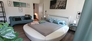 a bedroom with a bed and a blue couch at Il sogno di Elisa in Parma