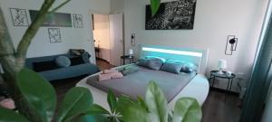 ein Schlafzimmer mit einem großen Bett und einer blauen Couch in der Unterkunft Il sogno di Elisa -romantico B&B nel centro di Parma in Parma