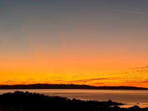 a sunset over a body of water at Luxury Adria Sea City & Whirpool, Mountain View Apartment in Makarska