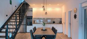a kitchen with a table and chairs and a staircase at Villa Raslina View in Raslina
