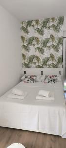 a white bed with two pillows and a wall at Villa Raslina View in Raslina +33 photos