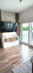 a living room with a large flat screen tv at Villa Raslina View in Raslina