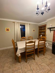 a dining room with a table and chairs at Foxs Farmhouse in Ballinrobe
