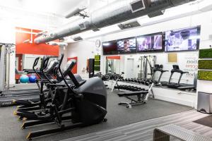 a gym with treadmills and elliptical machines at Deja Blue in Baptist Hospital Heliport