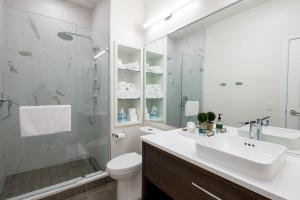 a bathroom with a sink and a toilet and a shower at Lofty Blues at the Brent Lofts in Baptist Hospital Heliport +16 photos