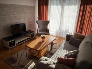 a living room with a couch and a coffee table at Apartman Tea in Čapljina