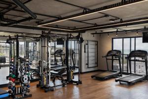 a gym with several tread machines in a room at Flat novo, moderno e super bem localizado in Tambaú