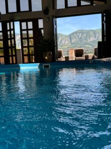a swimming pool with a view of the mountains at ANCA RESORT & SPA - Transilvania in Sălciua de Jos