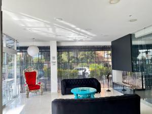 a living room with a couch and a table at Hotel Plaza Sport in Bogotá