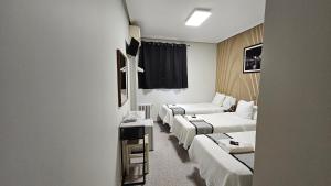 a hotel room with two beds and a couch at CH Chelo in Madrid