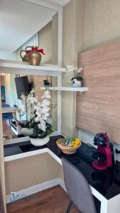 a room with a desk with a computer and flowers at Dusit Grand Park - Modern Studio Pool View in Jomtien Beach