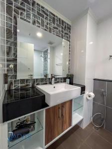 a bathroom with a white sink and a mirror at Dusit Grand Park - Modern Studio Pool View in Jomtien Beach +13 photos