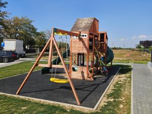 a play structure with a swing and a house at Studio Râșnov VMP Free Parking in Râşnov