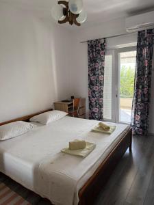 a bedroom with a large bed with two towels on it at Apartment Marjana in Podgora
