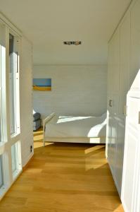 a bedroom with a bed and a wooden floor at Luxury summer house on Bolmsö in Bolmsö