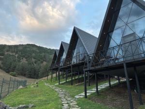 a building on top of a hill with glass at Space Trip Hotel in Artavaz