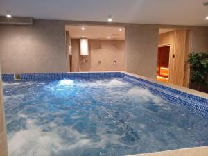 a large pool of water with clouds in it at NORD VISTA Premium Alpine and SPA Experience in Kopaonik