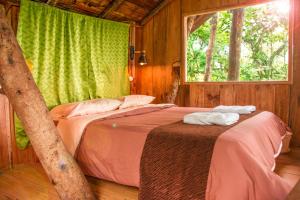 a bedroom with two beds and a window at Eden Treehouse in Mindo