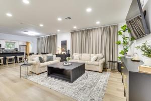 a living room with a couch and a table at Walk to City Center Modern Coral Springs Getaway in Coral Springs