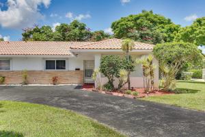 a house with a driveway in front of it at Walk to City Center Modern Coral Springs Getaway in Coral Springs