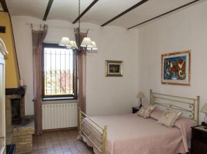 a bedroom with a bed and a window at Antico Casale Fossacieca in Civitanova Marche
