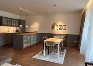 a kitchen with a table and chairs in it at Apartmány Panoráma Bojnice in Bojnice