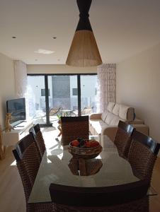 a living room with a table with chairs and a couch at Mirante Monte e Mar in Esposende +24 photos