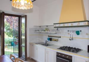 a kitchen with a sink and a stove at Antico Casale Fossacieca in Civitanova Marche