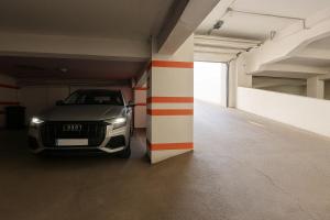 a audi car is parked in a garage at Mid Velvet Apartment, Free Parking, Self Check-in in Oradea