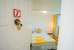 a small room with a bed and a door at Pousada Iwalu in Búzios +73 photos