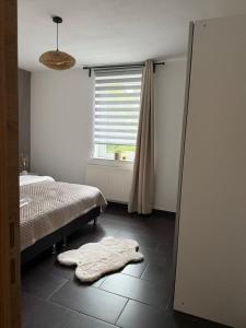 a bedroom with a bed and a blanket on the floor at Urban Cocoon in Liège