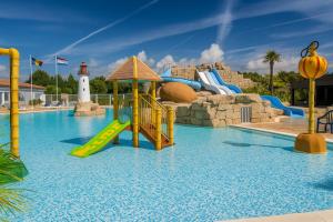 a water park with a slide and a lighthouse at Le Cocon De L'Océan in Saint-Hilaire-de-Riez
