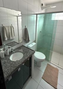 a bathroom with a sink and a toilet and a shower at Casa de Praia Encanto Tamandaré - A 300m das Piscinas Naturais in Tamandaré