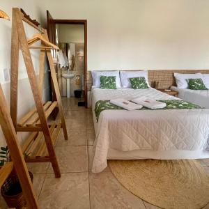 a bedroom with two beds and a staircase in it at Santo Amaro Chalés in Santo Amaro