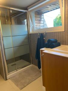 a bathroom with a shower and a sink at Charmante maison en pierre, avec terrasse et jardin privé in Jallais +22 photos