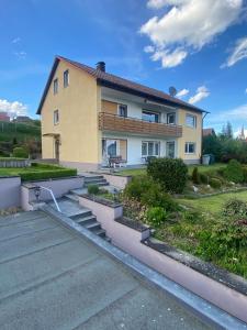 a house with stairs in front of it at Main Weindorf Unterkunft in Sulzfeld am Main