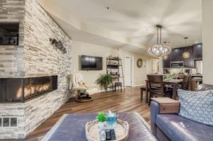 a living room with a couch and a fireplace at Peaceful Lift Line Condo 207 in Park City