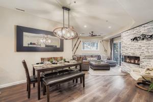a living room with a dining table and a fireplace at Peaceful Lift Line Condo 207 in Park City