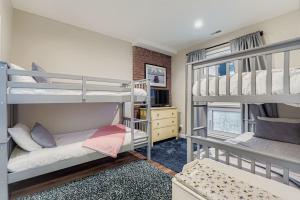 a room with two bunk beds and a desk at Peaceful Lift Line Condo 207 in Park City