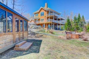 a large house with a porch and a house at Chalet L'Officier #1 et #2 Charlevoix in Petite-Rivière-Saint-François +41 photos