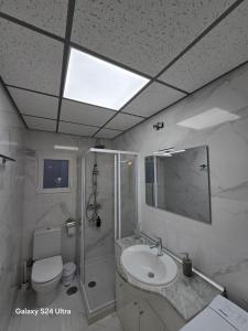 a bathroom with a sink and a toilet and a mirror at BEACH Arguineguin SEA VIEW 7 CHG FAMILY HOTEL in Arguineguín +40 photos