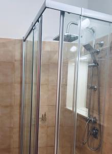 a shower with a glass door in a bathroom at La casa storica in Santu Lussurgiu