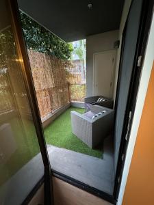 an outside view of a patio with a couch and grass at 1BR in Hollywood w patio & parking!! in Los Angeles