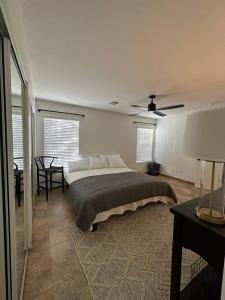a bedroom with a large bed and a ceiling fan at Hidden Gem Golf & Hiking in Queen Creek +24 photos