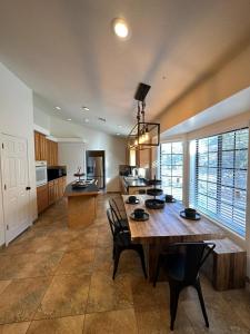 a large kitchen with a wooden table and chairs at Hidden Gem Golf & Hiking in Queen Creek