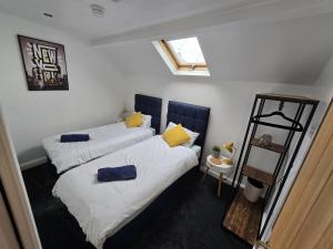 a bedroom with two beds and a ladder at 5 Bed Cottage Free Parking in Stainforth