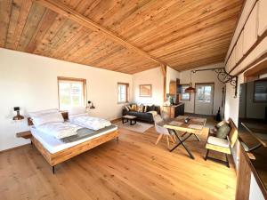 a bedroom with a bed and a living room at Weinturmsruhe in Bad Windsheim